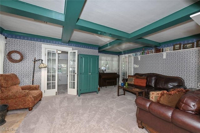 living room with french doors, coffered ceiling, beam ceiling, and wallpapered walls