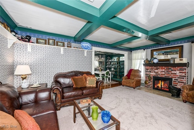 living room featuring wallpapered walls, a fireplace, coffered ceiling, and beam ceiling