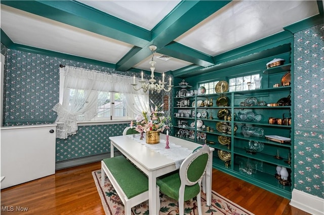 dining area with a baseboard radiator, wallpapered walls, a notable chandelier, and wood finished floors