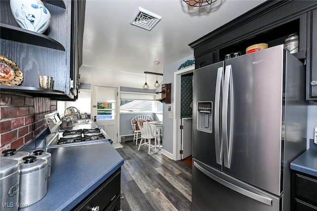 kitchen featuring visible vents, stainless steel fridge with ice dispenser, dark wood-style floors, dark cabinetry, and open shelves