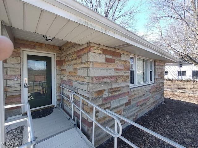 entrance to property featuring stone siding