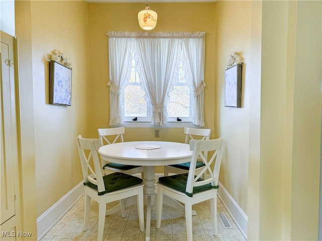 dining space with visible vents, baseboards, and light tile patterned floors