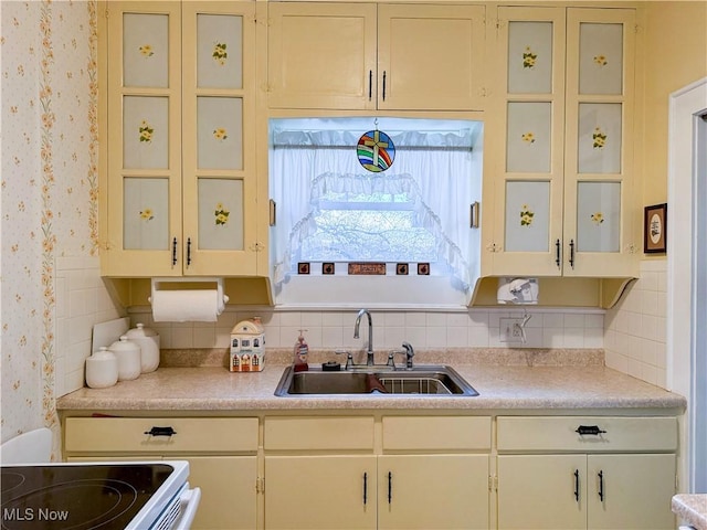 4109 Grand Central Ave, Vienna, WV 26105 - kitchen with backsplash, a sink, wallpapered walls, and light countertops
