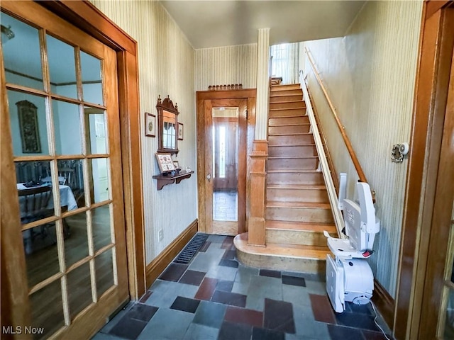 4109 Grand Central Ave, Vienna, WV 26105 - stairway with wallpapered walls, tile patterned floors, and baseboards