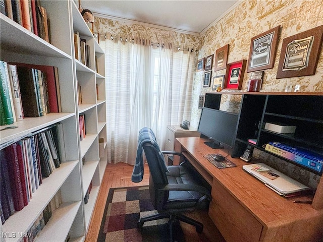 home office featuring crown molding and wallpapered walls