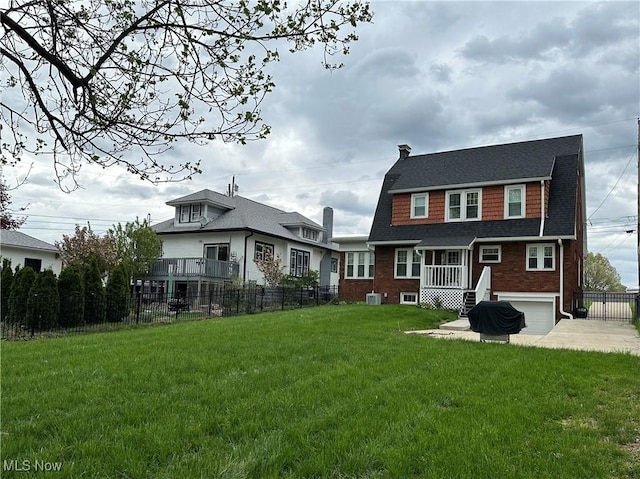 4109 Grand Central Ave, Vienna, WV 26105 - back of house with a garage, driveway, fence, and a lawn