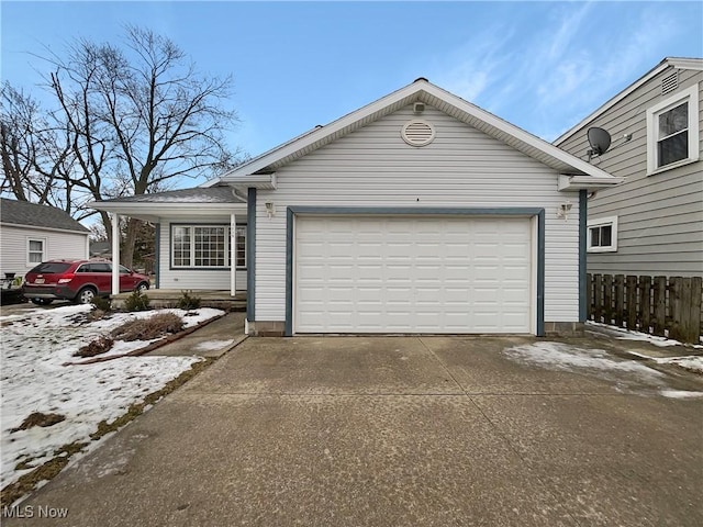 ranch-style house featuring a garage, fence, and concrete driveway