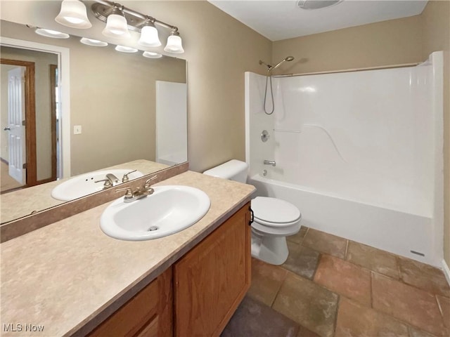 bathroom featuring bathtub / shower combination, vanity, and toilet