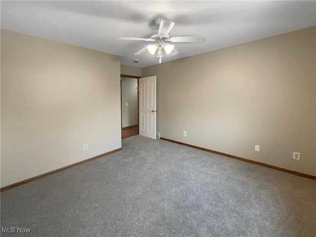 unfurnished room with carpet, ceiling fan, and baseboards