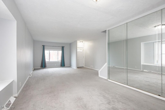 11915 Franklin Blvd, Lakewood, OH 44107 - carpeted empty room featuring a textured ceiling and baseboards
