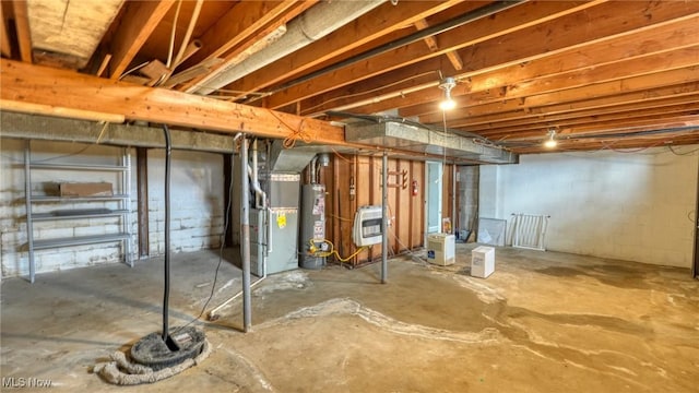 unfinished basement featuring heating unit and water heater