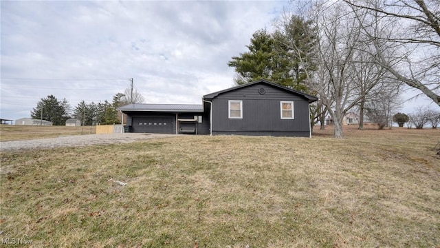 view of front of home with metal roof and a front lawn