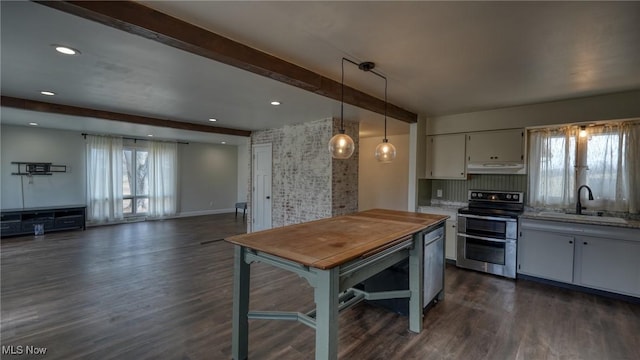 kitchen featuring range with two ovens, dark wood-style flooring, a sink, beamed ceiling, and under cabinet range hood