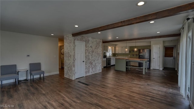 living area with brick wall, beamed ceiling, dark wood finished floors, and recessed lighting