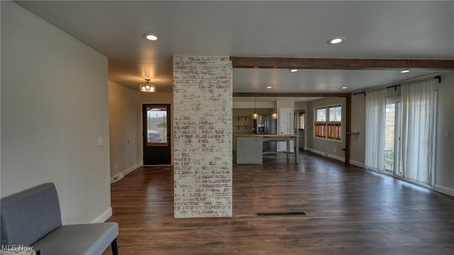 unfurnished living room featuring dark wood-style flooring, recessed lighting, visible vents, and baseboards