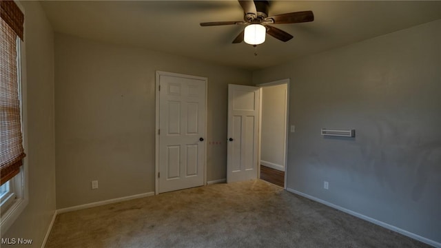 unfurnished bedroom with carpet floors, a ceiling fan, and baseboards