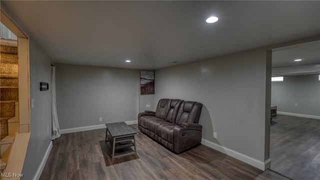 living area with recessed lighting, dark wood-style flooring, and baseboards