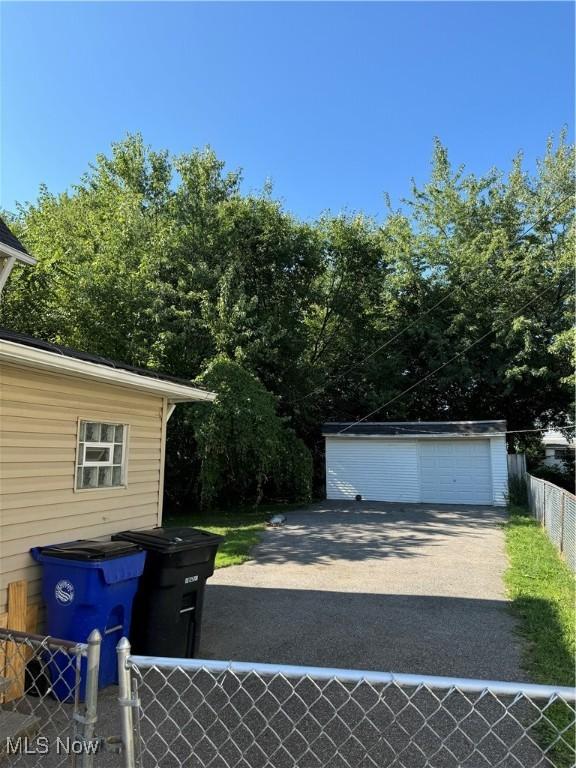 detached garage featuring fence