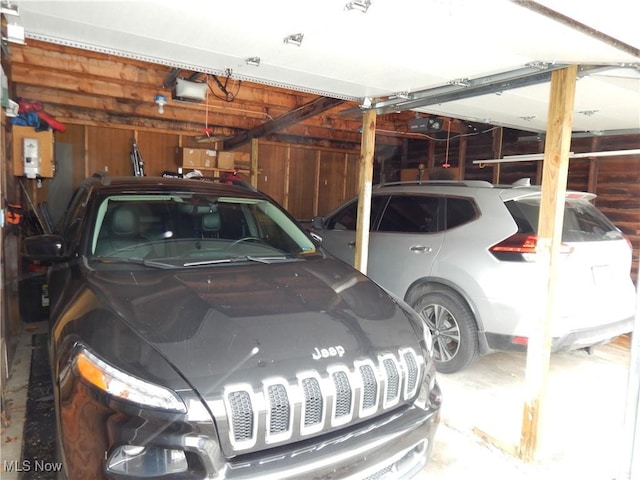 garage featuring wooden walls and a garage door opener