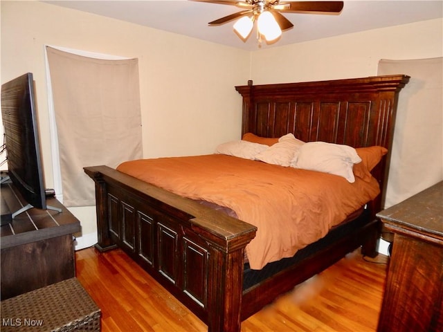 bedroom featuring a ceiling fan and wood finished floors