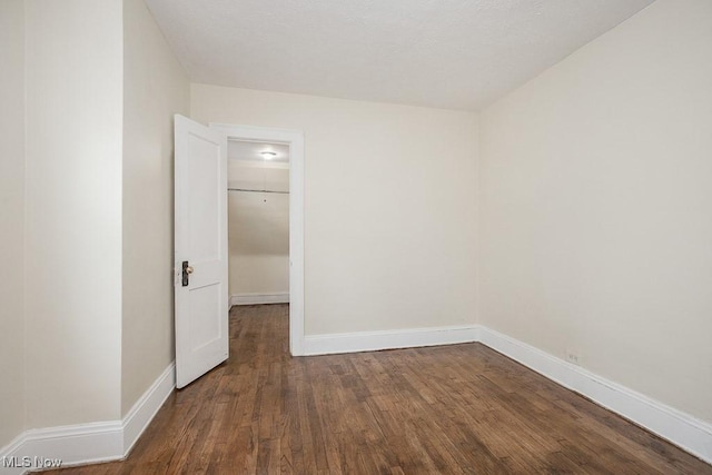 unfurnished room featuring wood finished floors and baseboards