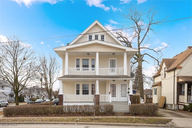 view of front of property featuring covered porch and a balcony