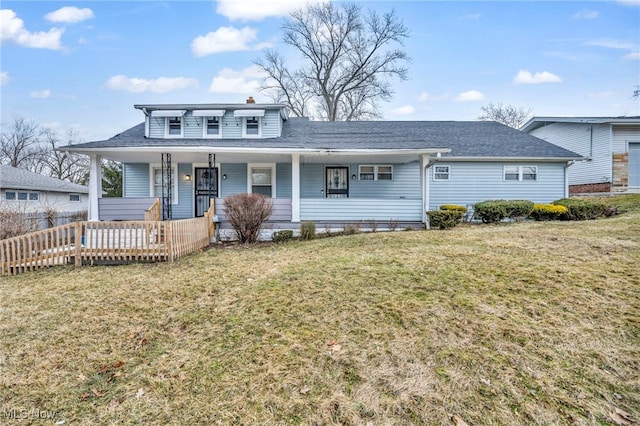 bungalow-style house featuring covered porch, a chimney, and a front lawn