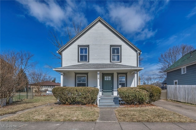 view of front of property with covered porch and fence