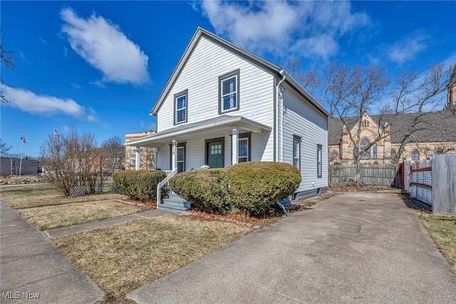 view of front of house featuring covered porch and fence