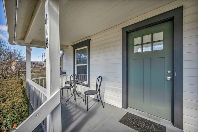 view of exterior entry with a porch