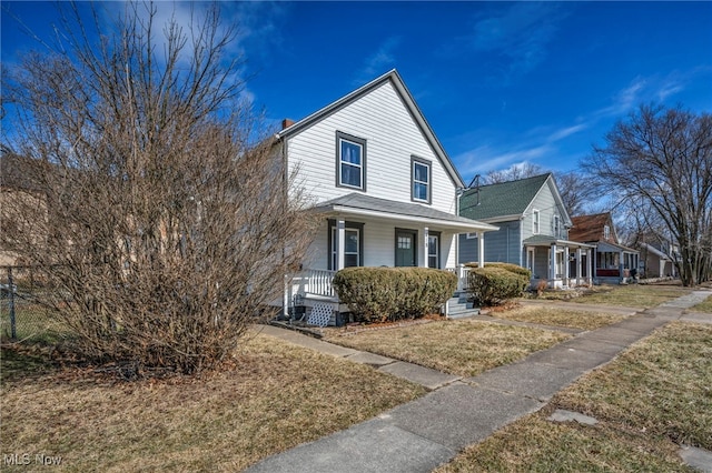 view of front of property with a porch and a front lawn