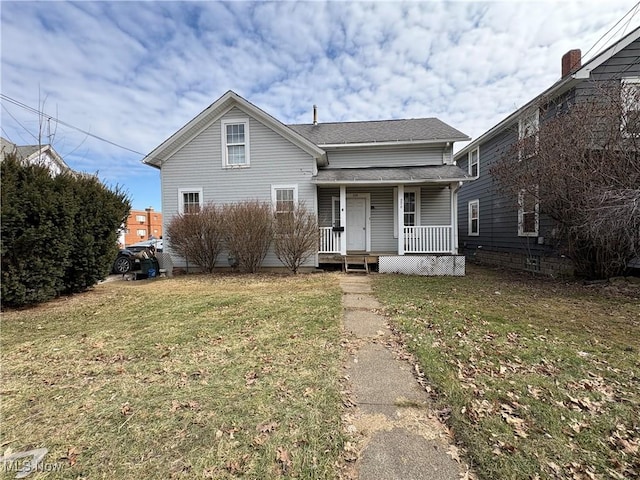 bungalow-style home featuring a shingled roof, a front yard, and covered porch