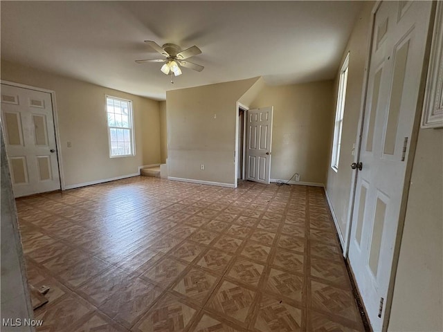 spare room featuring baseboards and a ceiling fan