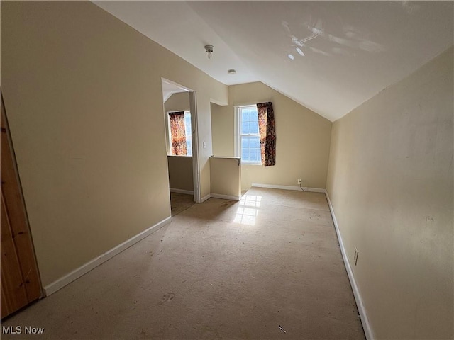 bonus room featuring lofted ceiling and baseboards