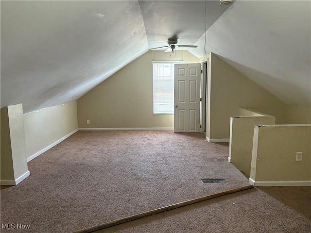 additional living space featuring ceiling fan, carpet, baseboards, and vaulted ceiling