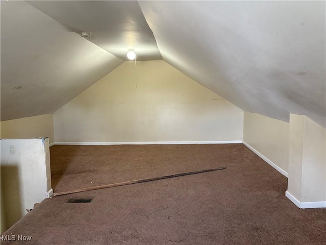 bonus room with carpet, baseboards, and vaulted ceiling