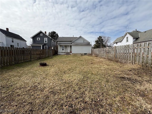 view of yard featuring entry steps and a fenced backyard