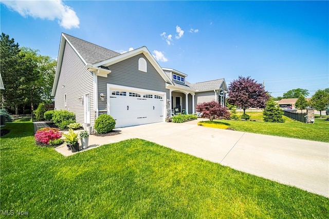 view of front facade with a garage, a front yard, and driveway