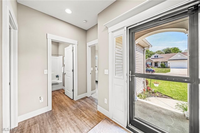 doorway to outside featuring recessed lighting, baseboards, and wood finished floors