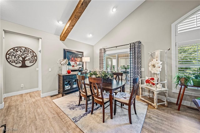 dining area with high vaulted ceiling, beam ceiling, baseboards, and wood finished floors