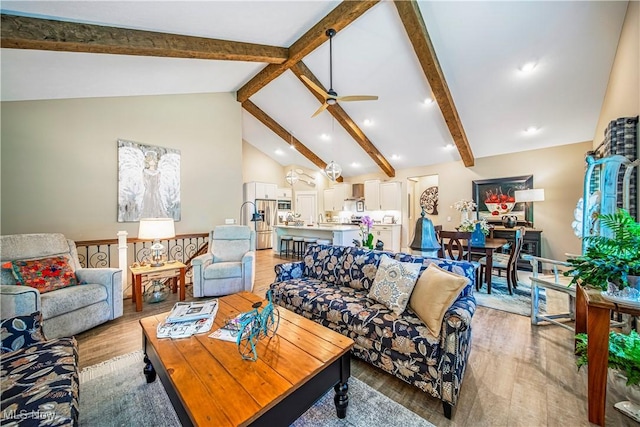 living area featuring ceiling fan, high vaulted ceiling, recessed lighting, light wood-type flooring, and beamed ceiling