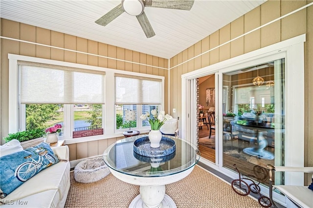 sunroom / solarium featuring ceiling fan