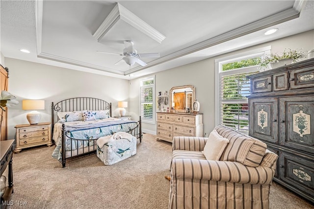 bedroom with ceiling fan, a tray ceiling, crown molding, carpet flooring, and recessed lighting