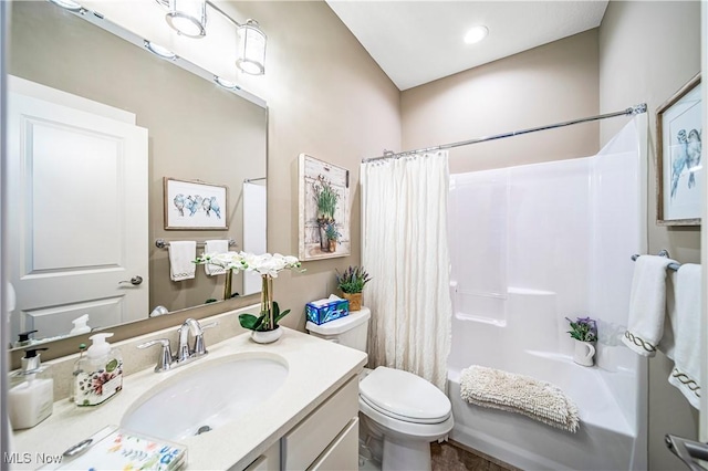 full bathroom with vanity, shower / bath combination with curtain, and toilet