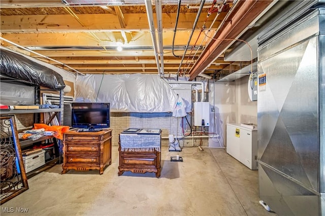 unfinished basement featuring fridge and heating unit