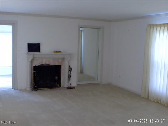 unfurnished living room with carpet and a premium fireplace