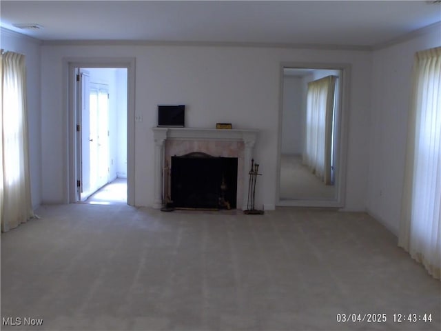 unfurnished living room with carpet and a fireplace