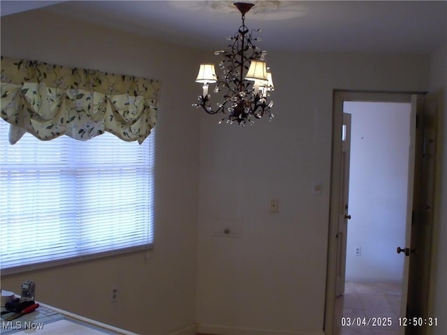 unfurnished dining area with an inviting chandelier