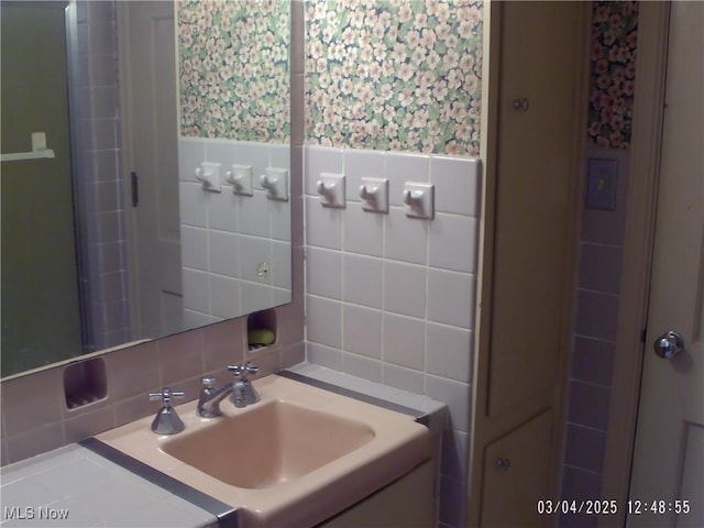 bathroom featuring tile walls and vanity