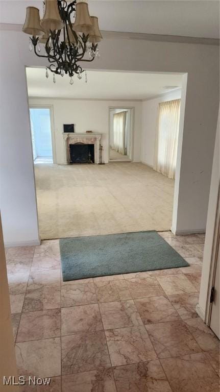 unfurnished living room with an inviting chandelier, a fireplace, and ornamental molding